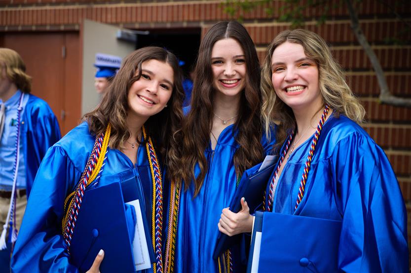 A group of graduates wearing blue robes